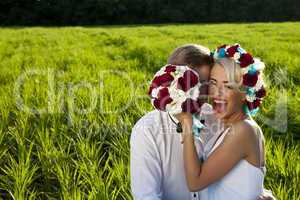 Happy bride and groom on the bright green field