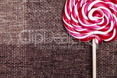 red lollipop caramel brown background