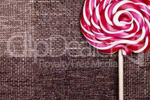 red lollipop caramel brown background