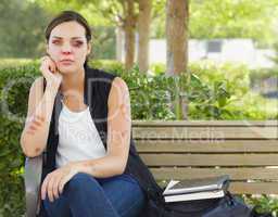 Depressed Bruised and Battered Young Woman on Bench