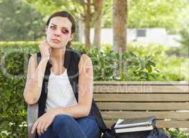 Depressed Bruised and Battered Young Woman on Bench