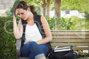 Depressed Young Woman Sitting on Bench at Park
