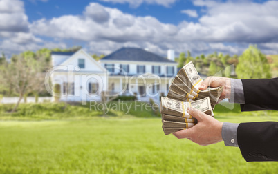 Man Handing Over Hundreds of Dollars in Front of House