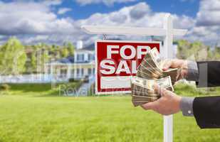 Man Handing Over Money in Front House For Sale, Sign