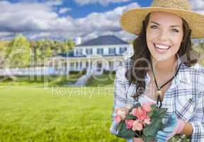 Young Woman Gardening in Front of Beautiful House
