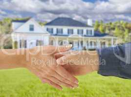 Man and Woman Shaking Hands in Front of New House