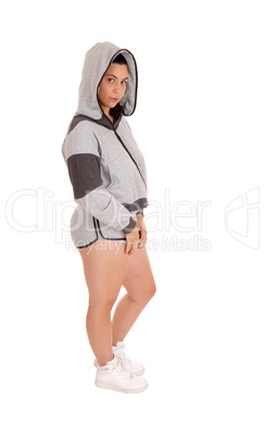 Standing woman in gray hoodie and shorts.