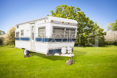 Classic Old Camper Trailer In Grass Field