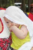 little baby in white mantlet