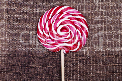 red lollipop caramel brown background