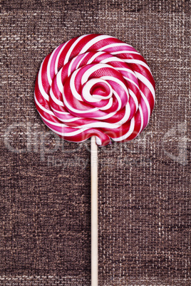 red lollipop caramel brown background