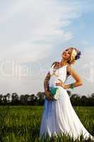 Beautiful bride blond blue eyes green field