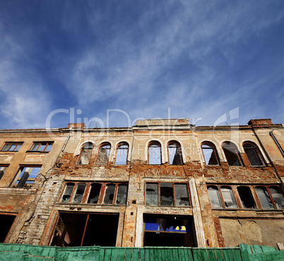 Facade of old destroyed house. Wide-angle view.