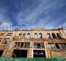 Facade of old destroyed house. Wide-angle view.