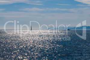 Sailboat and power boat on reflective water