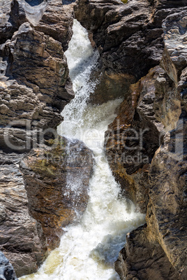 Waterfall Flowing Between the Lava Stones