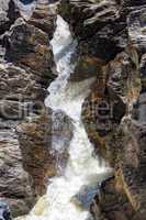 Waterfall Flowing Between the Lava Stones