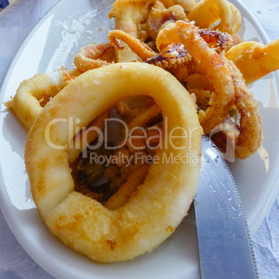 Plate of fried calamari with knife edge