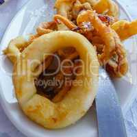 Plate of fried calamari with knife edge