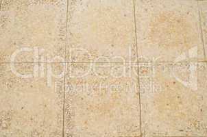 Old beige stone floor tiles with mosaic effect