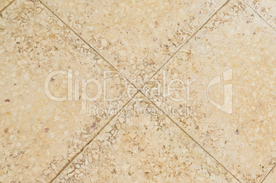 Old beige stone floor tiles with mosaic effect