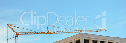 Crane arm on the blue sky in Cyprus and building