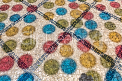 Multicolored Shadows from Decorative Balls on Paving Stone