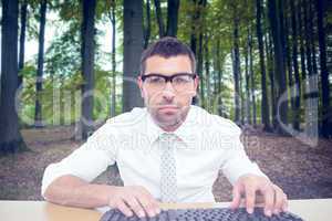 Composite image of businessman working at his desk