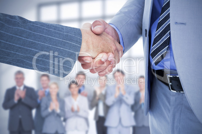 Composite image of businessman shaking hands with a co worker Composite image of businessman shaking hands with a co worker