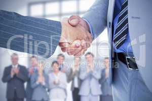 Composite image of  businessman shaking hands with a co worker