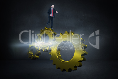 Composite image of smiling young businessman in suit running