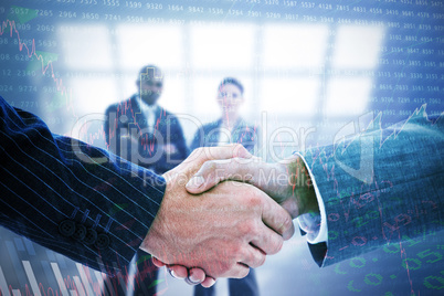 Composite image of business people shaking hands