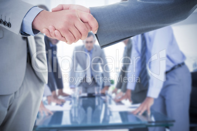 Composite image of business handshake