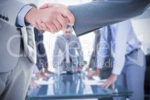 Composite image of business handshake