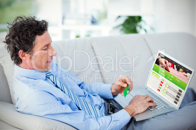 Composite image of businessman doing online shopping on couch