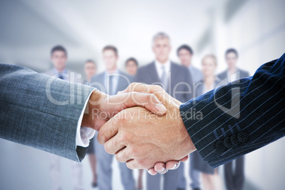 Composite image of business people shaking hands