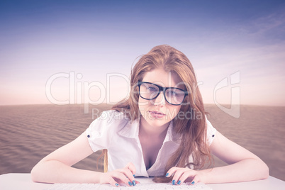 Composite image of pretty redhead typing on keyboard