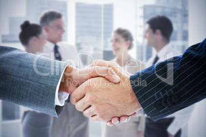 Composite image of business people shaking hands