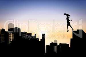 Composite image of businesswoman stepping with umbrella