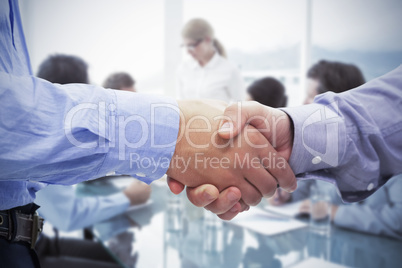 Composite image of two men shaking hands