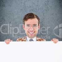 Composite image of geeky businessman showing card