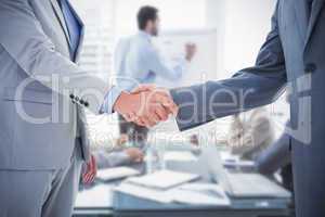 Composite image of business handshake