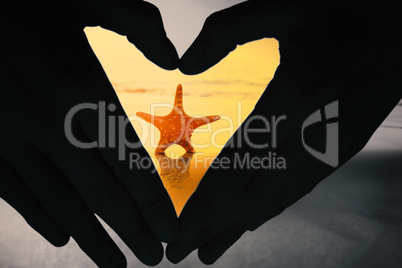 Composite image of woman making heart shape with hands