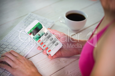 Composite image of woman using her smartphone Composite image of woman using her smartphone