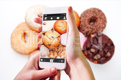 Composite image of hand holding smartphone