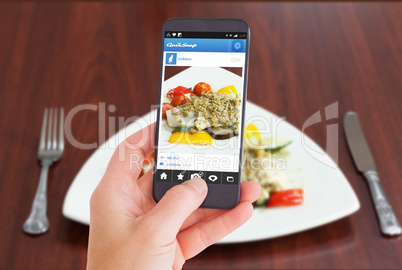 Composite image of female hand holding a smartphone