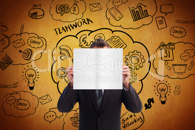 Composite image of businessman holding a white card in front of