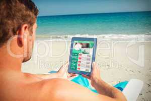 Composite image of man using digital tablet on deck chair at the