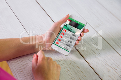 Composite image of woman using smartphone Composite image of woman using smartphone