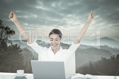 Composite image of businesswoman celebrating a great success